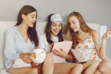 Three girls have pajamas party at home