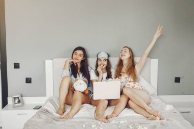 Three girls have pajamas party at home