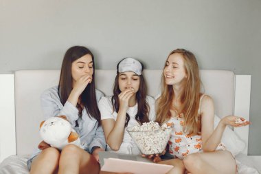 Three girls have pajamas party at home