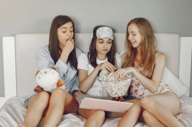 Three girls have pajamas party at home