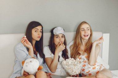 Three girls have pajamas party at home