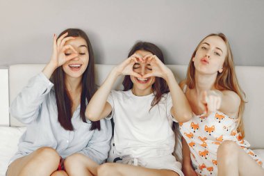 Three girls have pajamas party at home