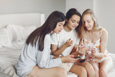 Three girls have pajamas party at home