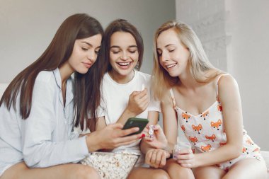 Three girls have pajamas party at home