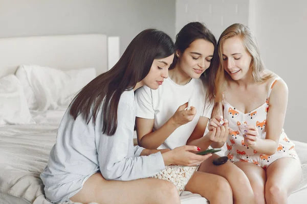 Three girls have pajamas party at home