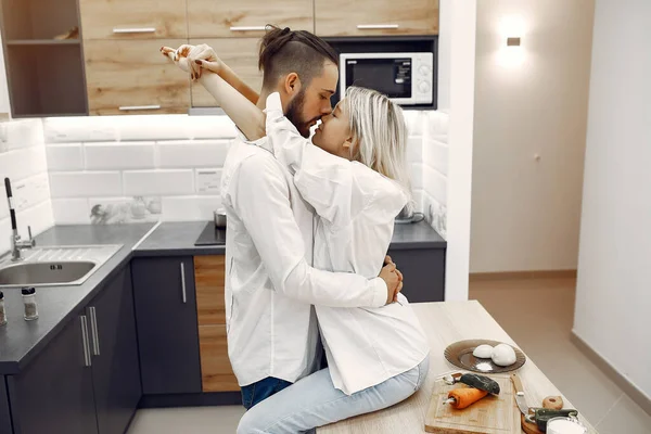 Beautiful couple spend time at home in a kitchen — Zdjęcie stockowe