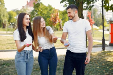 People have fun in a park with holi paints