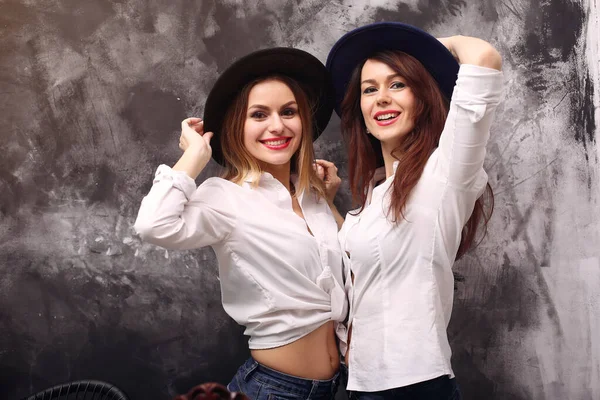 Fashion girls posing on a gray background — Stock Photo, Image