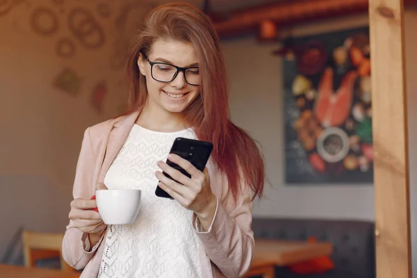 stock image Elegant woman in a pink jacket spend time in a cafe