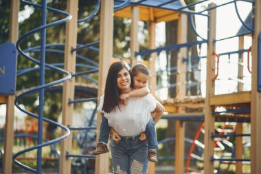 Anne ve küçük çocuk oyun parkında