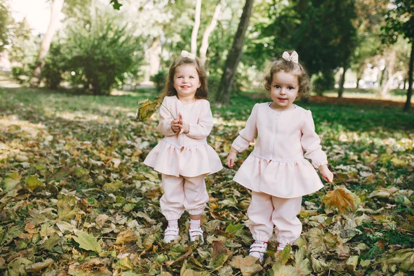 Söta småsystrar som plauderar i en vårpark — Stockfoto