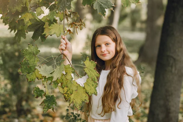 Kleines Mädchen im Park in weißer Bluse — Stockfoto