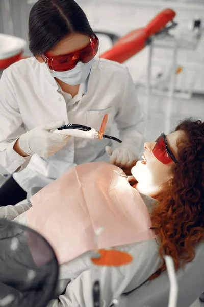 Mooi meisje zitten in de tandartsen kantoor — Stockfoto