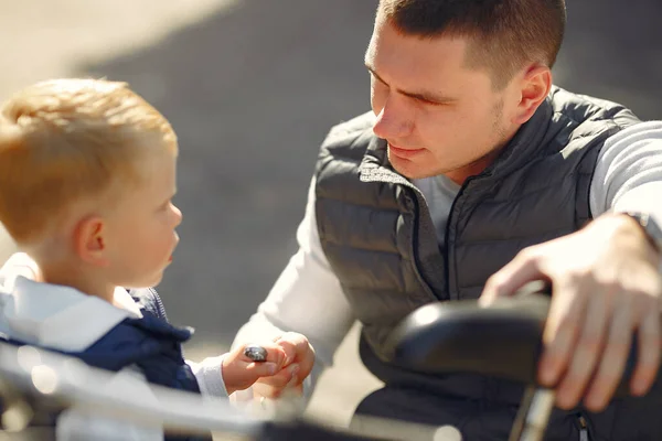 Padre con hijo repare la moto en un parque —  Fotos de Stock