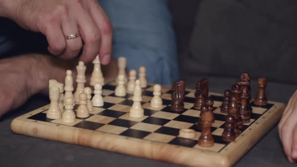 Cropped view of process of playing chess on sofa at home — Stock Video