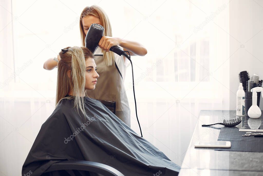 Woman drying hair in a hairsalon