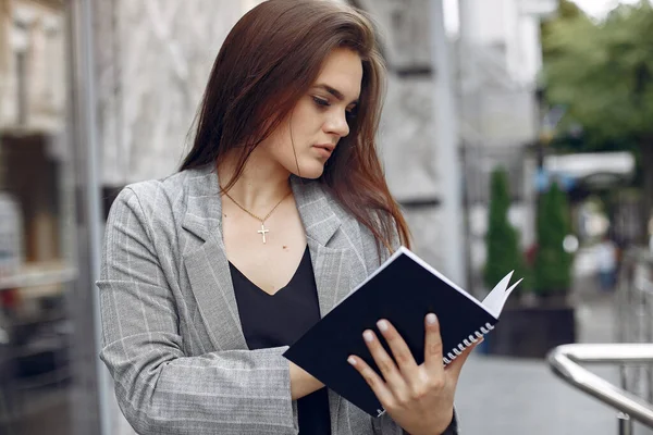 Elegante empresaria que trabaja en una ciudad y usa el cuaderno —  Fotos de Stock