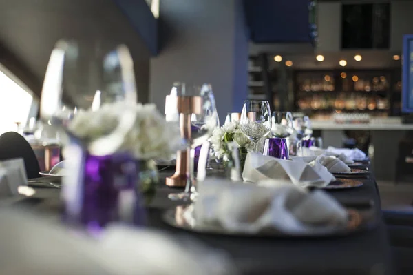 Table setup at dinner party, purple color theme
