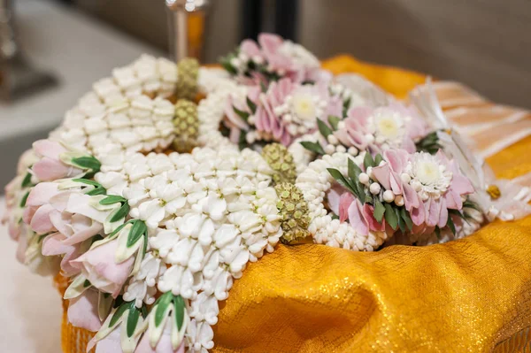 Thai traditional wedding accessories, white garland made from jasmin on golden tray