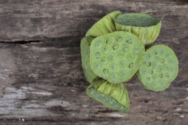 Lotus seed or lotus nut. The traditional Chinese and Indian medicine. Good for healty and can eat both fresh and dried seed as a snack dessert or cooking as a food. Shooting on vintage wood surface table.