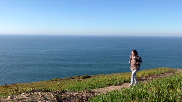 Молодая Женщина Идет Тропинке Холме Фоне Синего Океана — стоковое видео