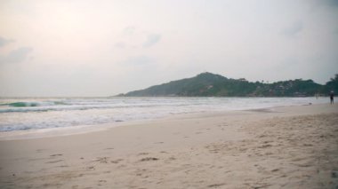 Young healthy woman jogging at the beach at the sunrise time.