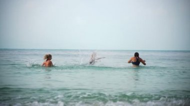 Friends splashing in the water.