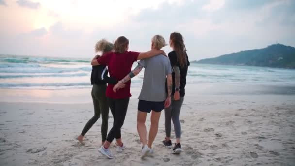 Group of four young women walking at the beach at the sunrise. — 비디오