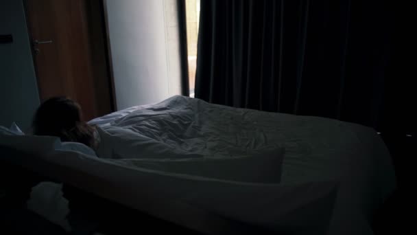 Una joven mujer caucásica viajera se despierta y abre cortinas oscuras — Vídeo de stock