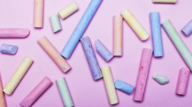 Pembe bir arka plan üzerinde renkli boya kalemi