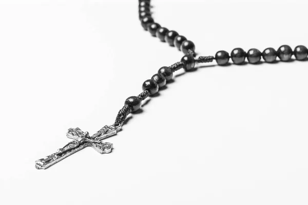 Rosary and a cross on a light gray background. — Stock Photo, Image