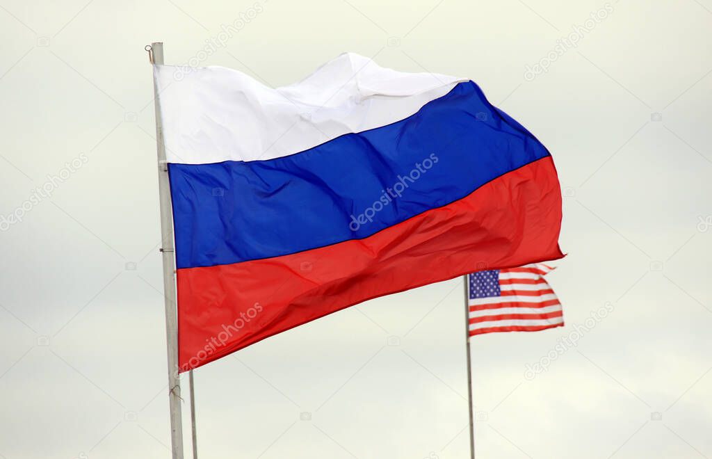 The Russian flag on the background of the American flag