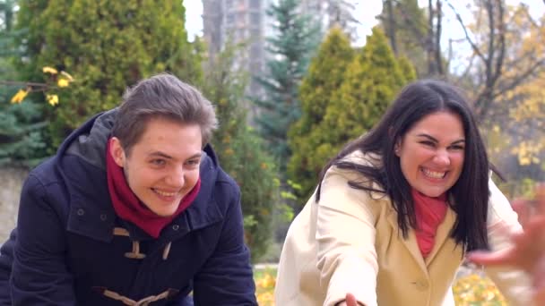 Feliz família brincando no parque com folhas amarelas no outono pa — Vídeo de Stock