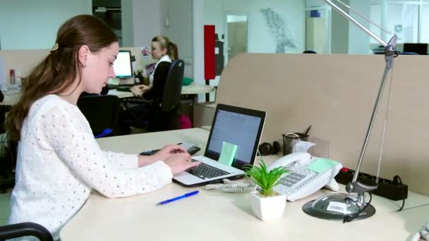 Jonge zakenvrouw werkt op kantoor op de computer. — Stockvideo