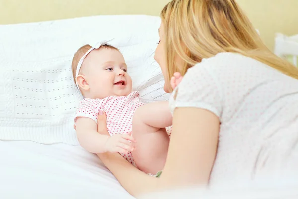 Baby girl laughing smiling with her mother playing — Stock Photo, Image