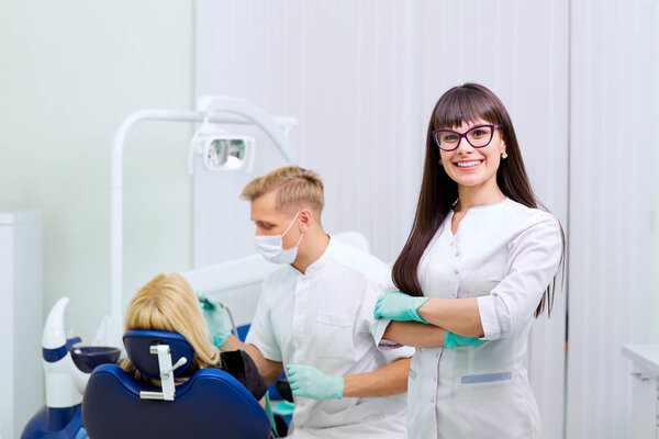 Dentist woman  in glasses smiling  on background equipment