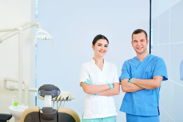 Οδοντίατρος αρσενικό και βοηθός γυναίκες ένα οδοντικό γραφείο εργασίας — Φωτογραφία Αρχείου