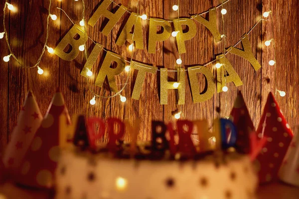 Happy birthday cake  on the background of garlands and letters — Stock Photo, Image