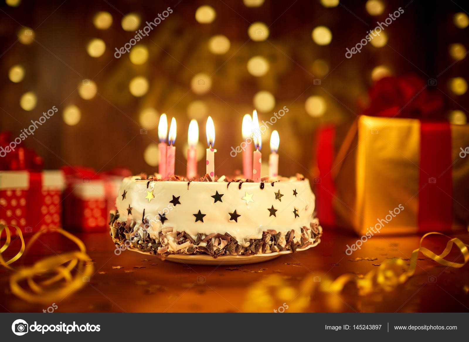 Happy birthday cake with candles on the background of garlands a Stock