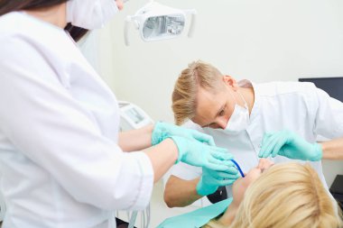 Diş hekimi adam ve Yardımcısı kadın sen CLI için tedavi diş