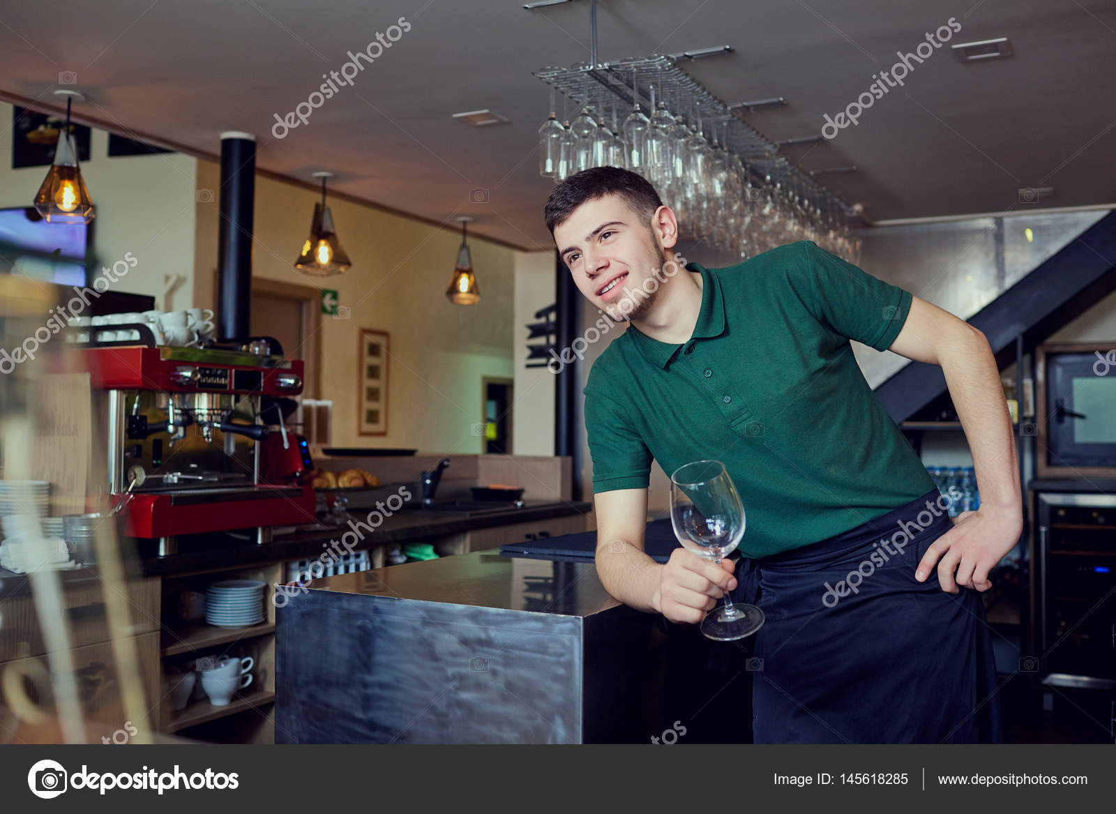 A guy is barista barista waiter at bar cafe restaurant in the w Stock