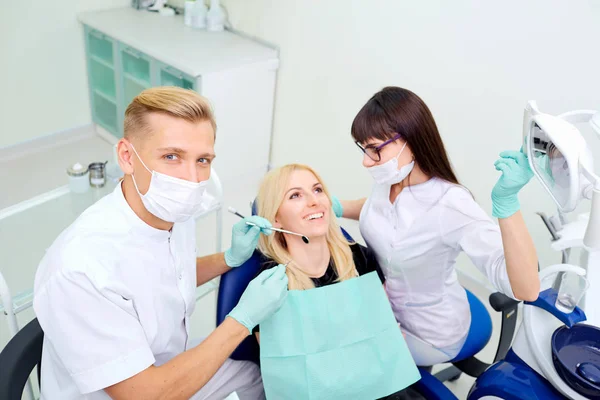 Le dentiste et son assistante soignent les dents de la fille — Photo