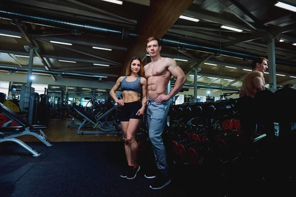 A beautiful sports body couple in the gym