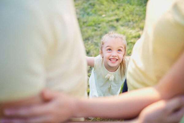 Child with parents in the park.