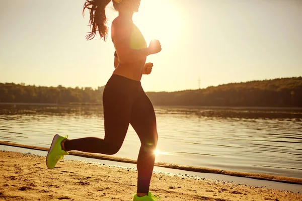 A brunette runner woman runs in the park jogging — Stock Photo, Image