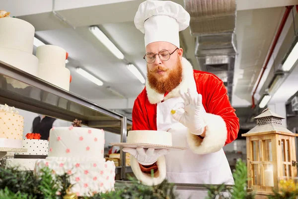 Weihnachtsmann Claus backt an Heiligabend in der Küche einen Kuchen — Stockfoto