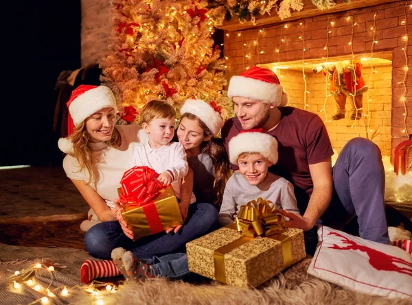 The family gives presents in a room on Christmas Day. — Stock Photo, Image