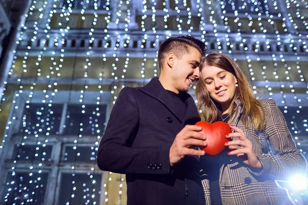 Pareja cariñosa con corazón en las manos al aire libre . — Foto de Stock