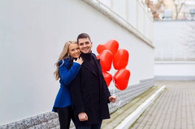 Seven çift sokakta kırmızı Kalp balonlar ile.