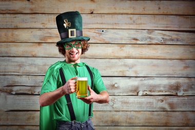 Curly funny man in St. Patricks hat .